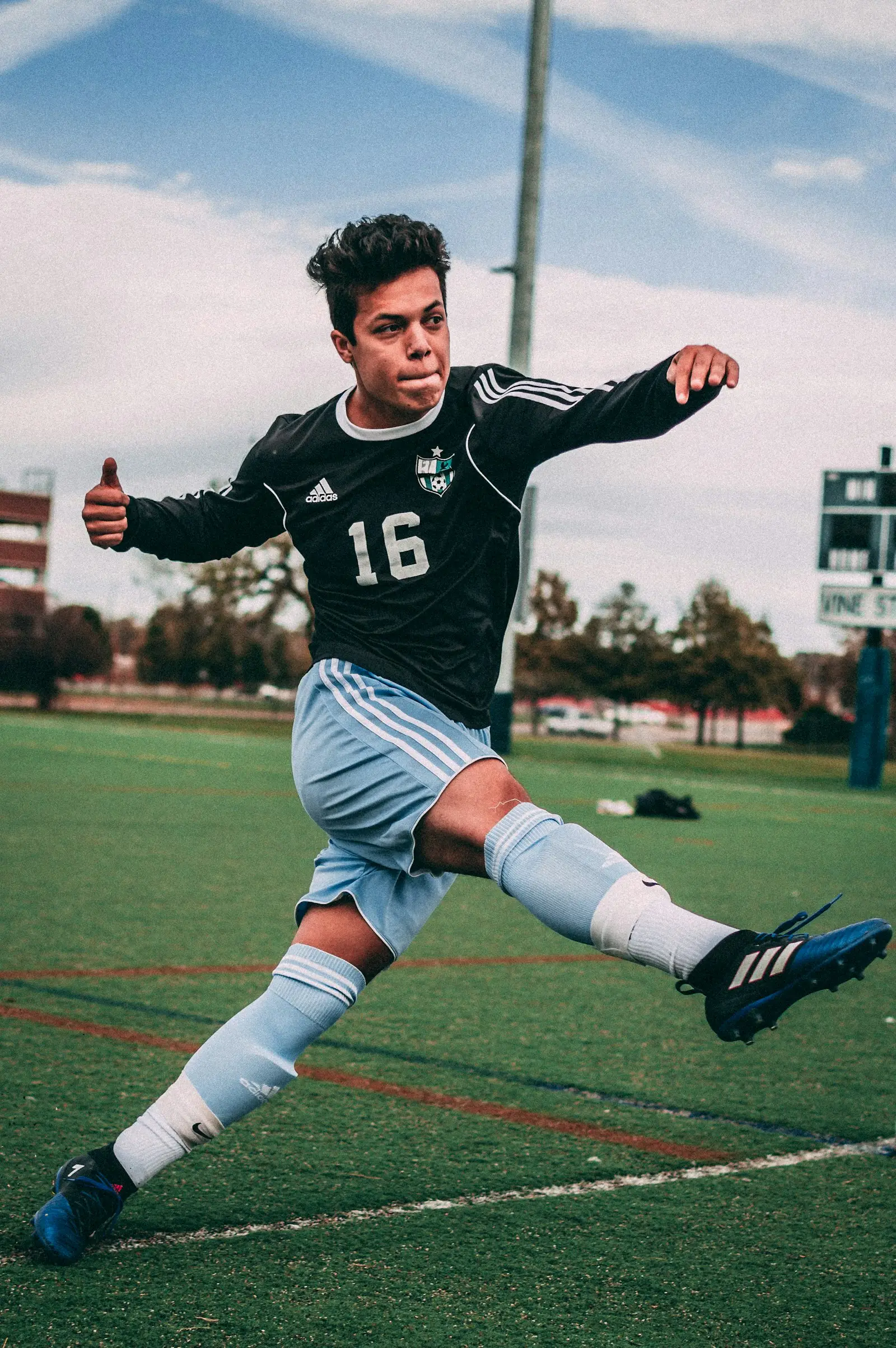 Young footballer striking the ball on a grass pitch