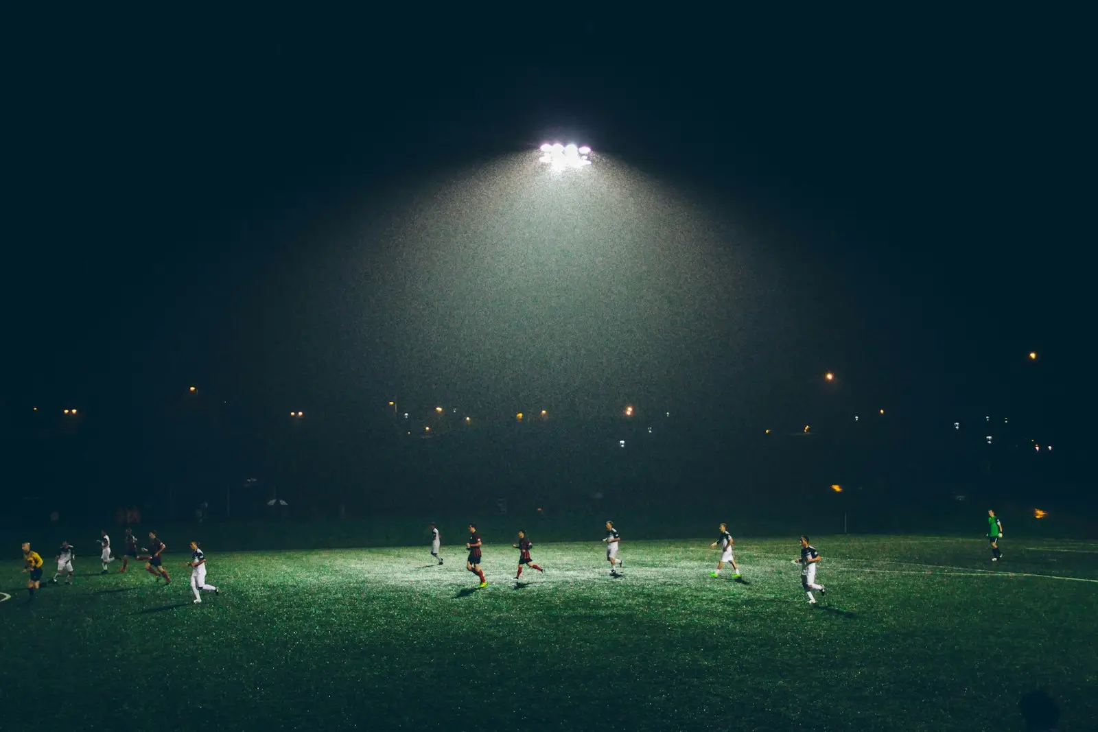 Night-time football match under a floodlight